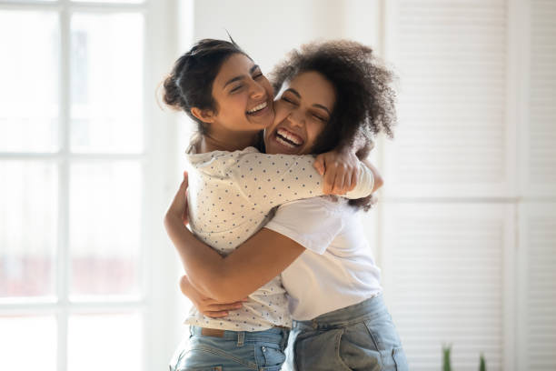 Two american girls are hugging each other